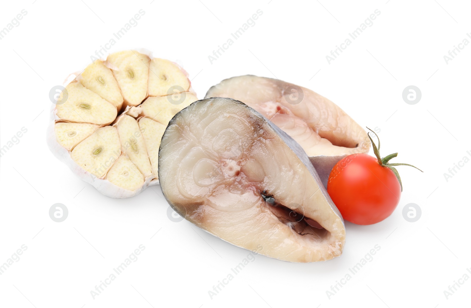 Photo of Pieces of mackerel fish with cherry tomato and garlic on white background