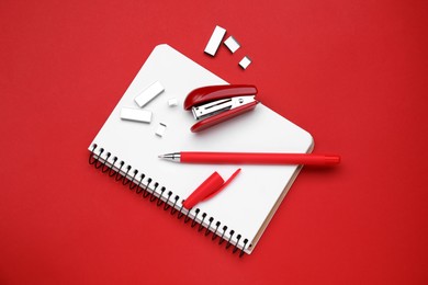 Photo of Flat lay composition with new stapler on red background