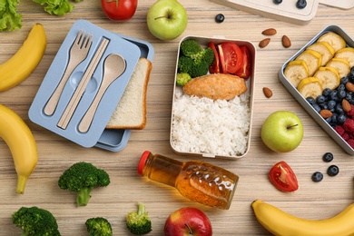 Flat lay composition with healthy food  on wooden table. School lunch