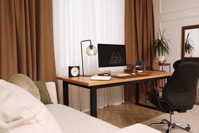 Stylish room interior with comfortable workplace near window