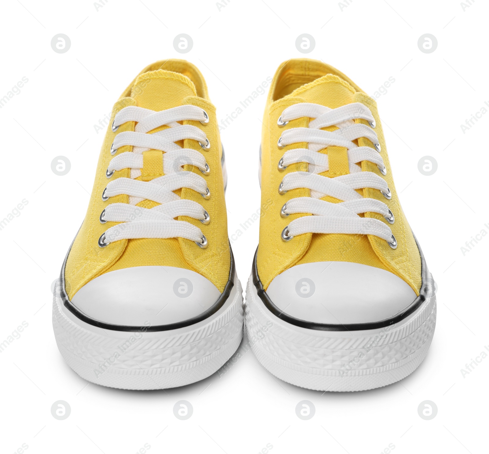 Photo of Pair of yellow classic old school sneakers on white background