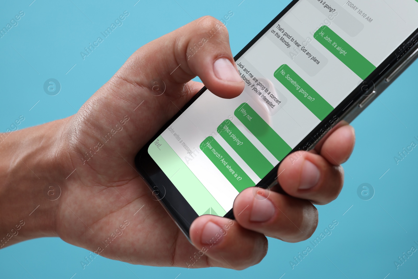 Image of Man texting with friend using messaging application on smartphone against light blue background, closeup