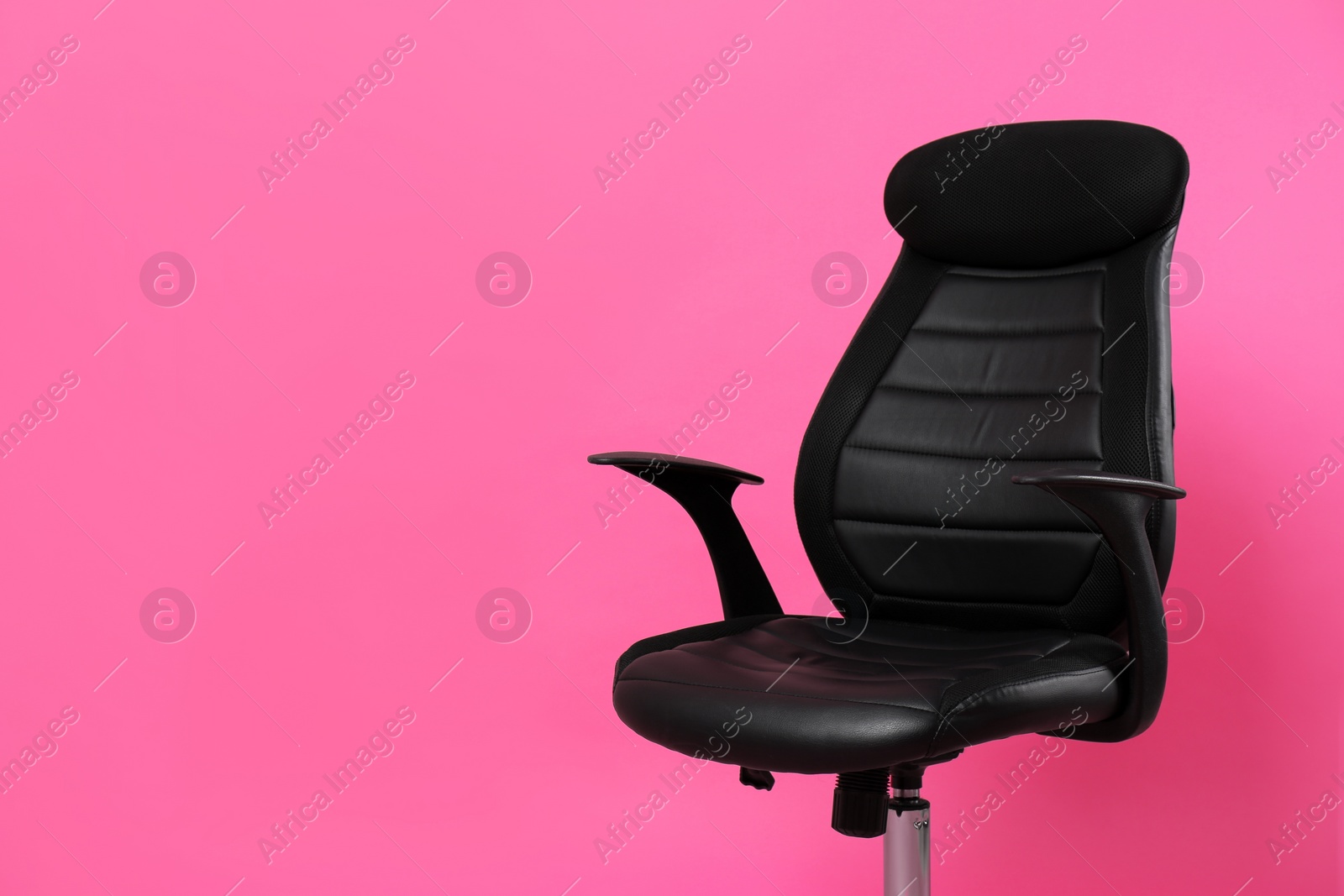 Photo of Comfortable office chair on pink background, space for text