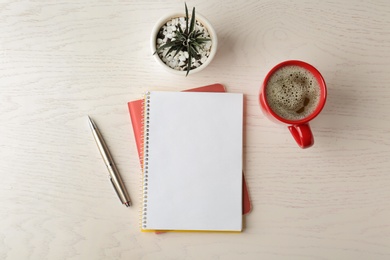 Photo of Flat lay composition with office stationery and cup of coffee on white wooden table. Space for design