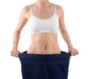 Photo of Young slim woman wearing oversized jeans on white background, closeup