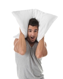 Young man with soft pillow on white background