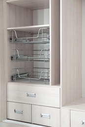 Photo of Empty wooden wardrobe with shelves and drawers as background