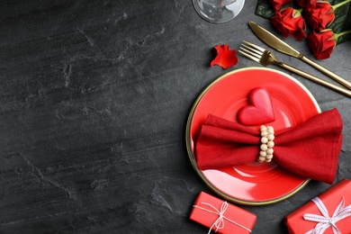 Photo of Beautiful place setting on black table, flat lay with space for text. Valentine's day romantic dinner