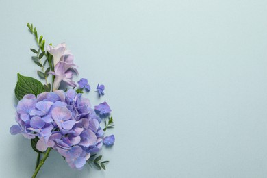 Photo of Beautiful composition with hortensia flowers on light dusty background, flat lay. Space for text