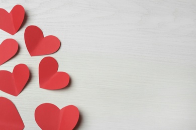 Photo of Red paper hearts on white wooden background, flat lay with space for text. Happy Valentine's Day