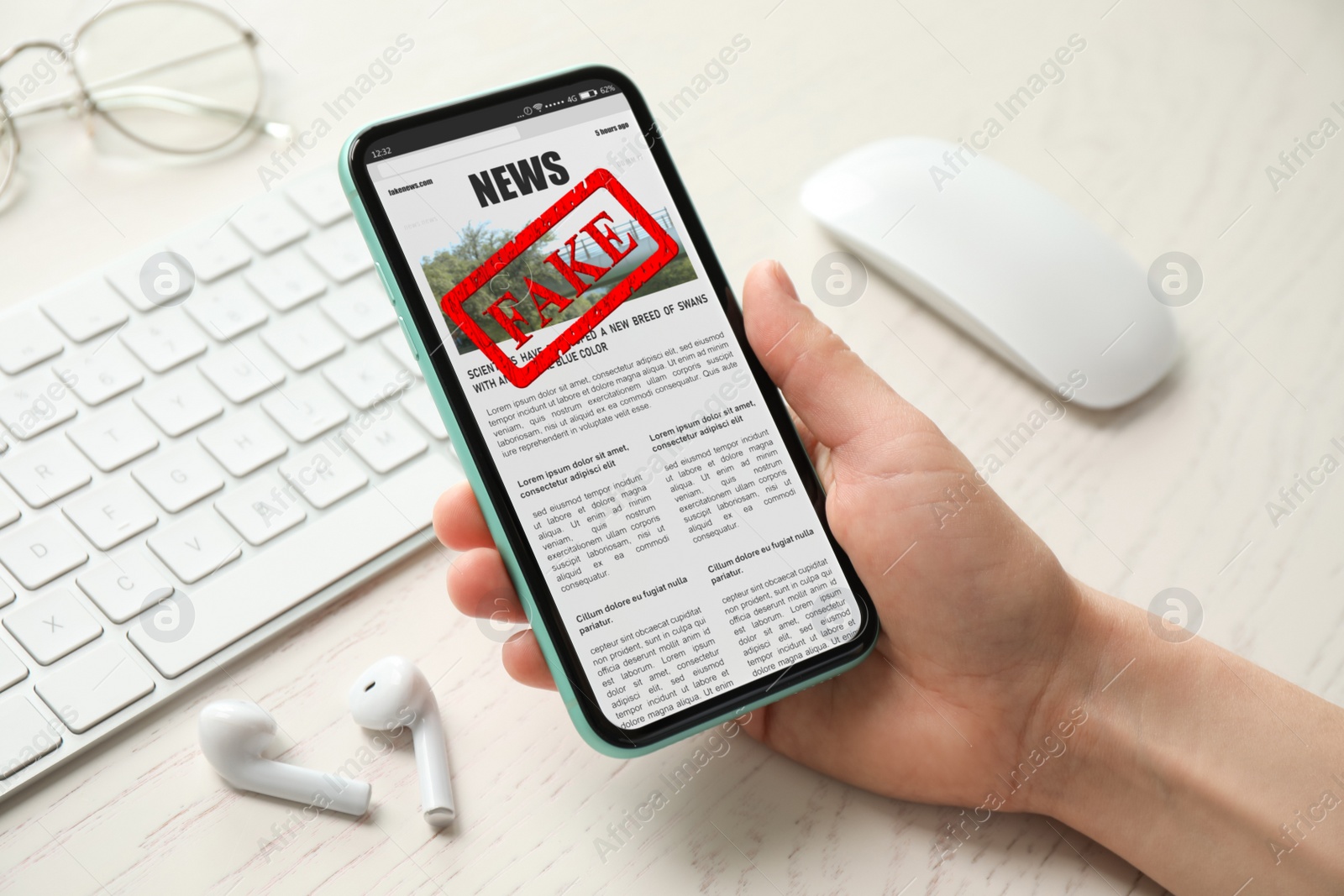 Image of Fake information. Woman using mobile phone to read news at wooden table, closeup