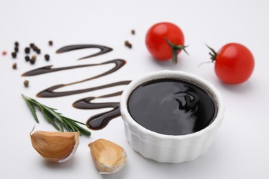 Photo of Organic balsamic vinegar and cooking ingredients on white background