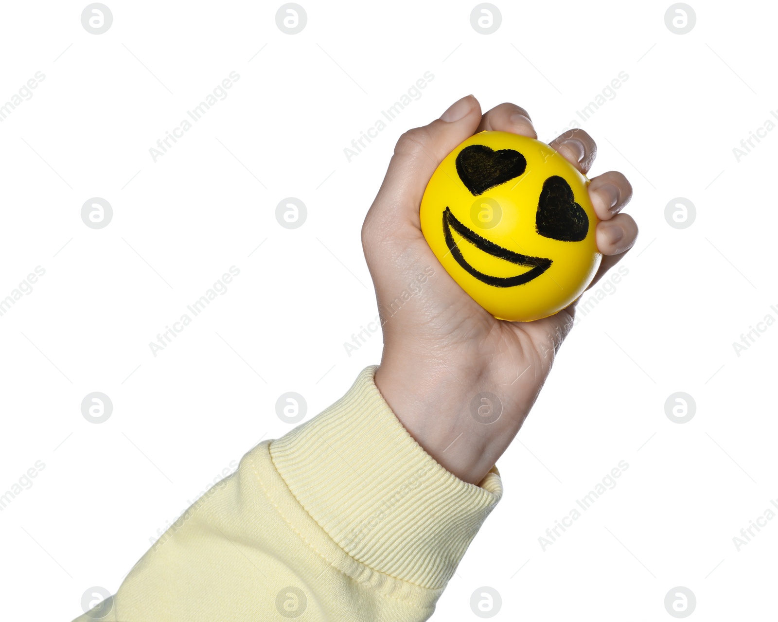 Photo of Woman squeezing antistress ball with funny face on white background, closeup