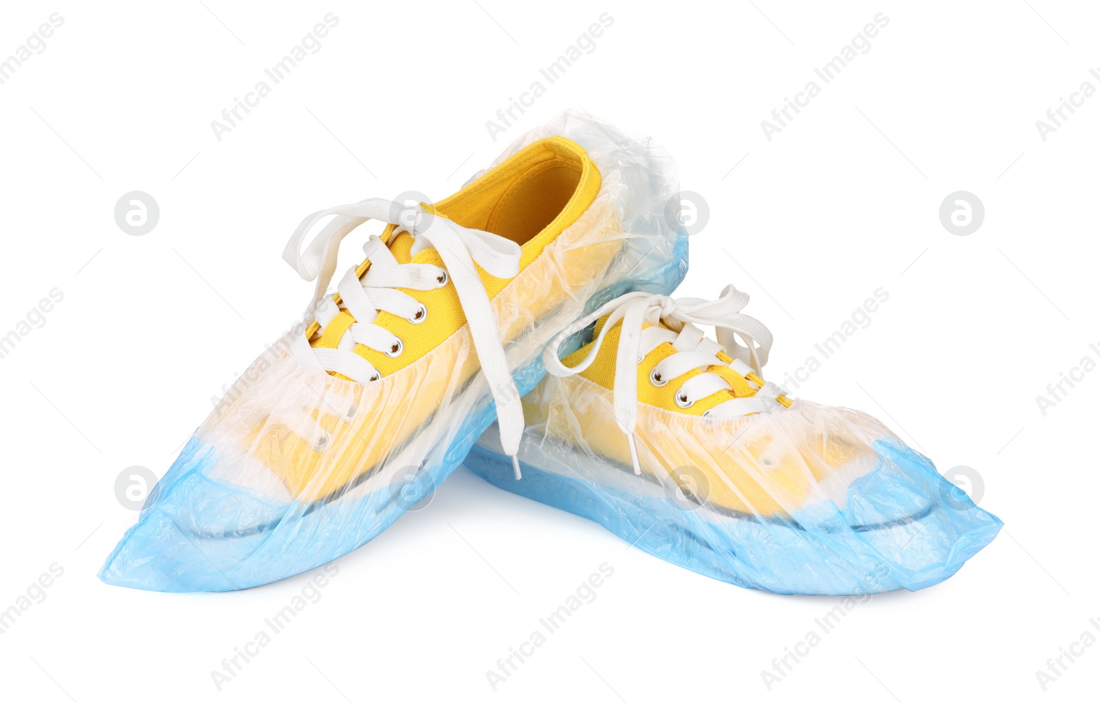 Photo of Sneakers in blue shoe covers isolated on white