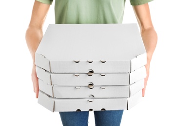 Woman holding cardboard pizza boxes on white background