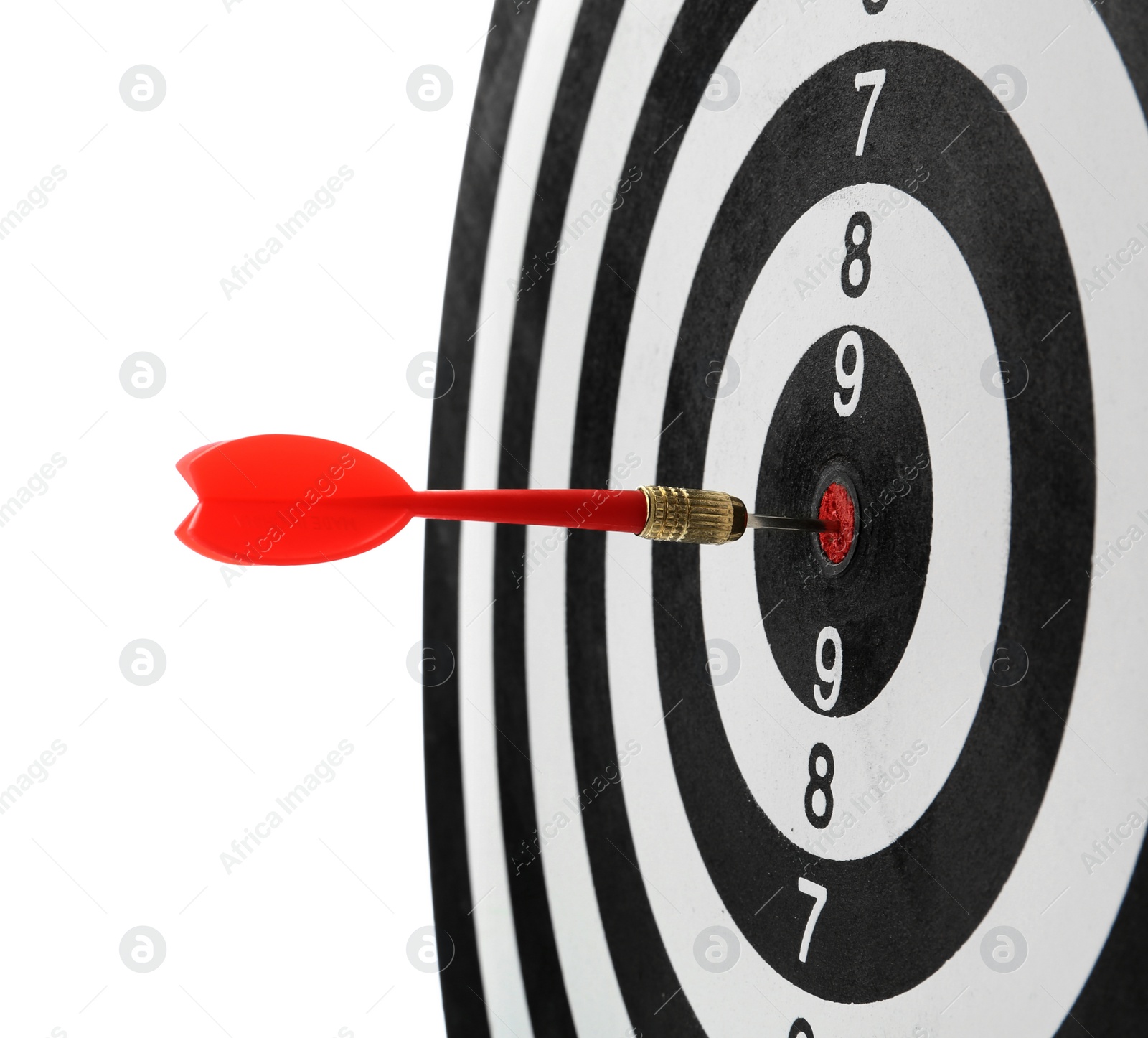 Photo of Red arrow hitting target on dart board against white background