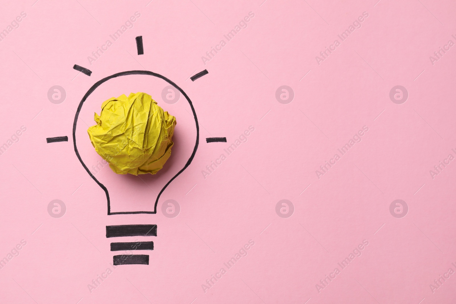 Photo of Idea concept. Light bulb made with crumpled paper and drawing on pink background, top view. Space for text