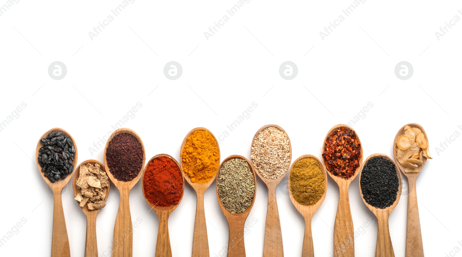 Photo of Composition with different aromatic spices in wooden spoons on white background