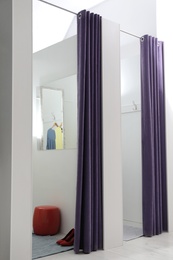 Photo of Empty dressing rooms in fashion store. Stylish interior