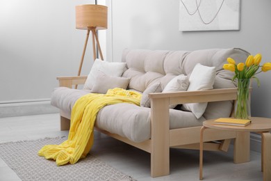 Photo of Comfortable sofa in stylish living room interior