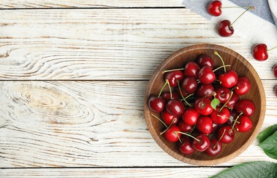 Photo of Flat lay composition with ripe sweet cherries on white wooden table. Space for text