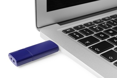 Usb flash drive attached into laptop on white background