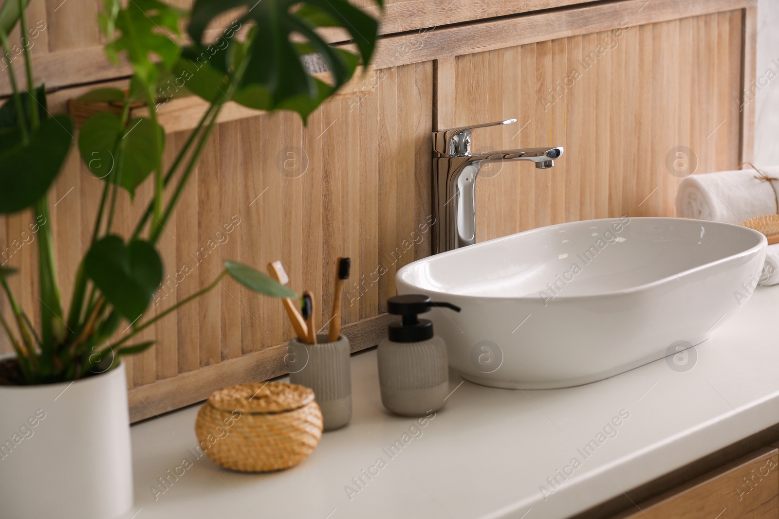 Photo of Stylish vessel sink near wooden wall in modern bathroom