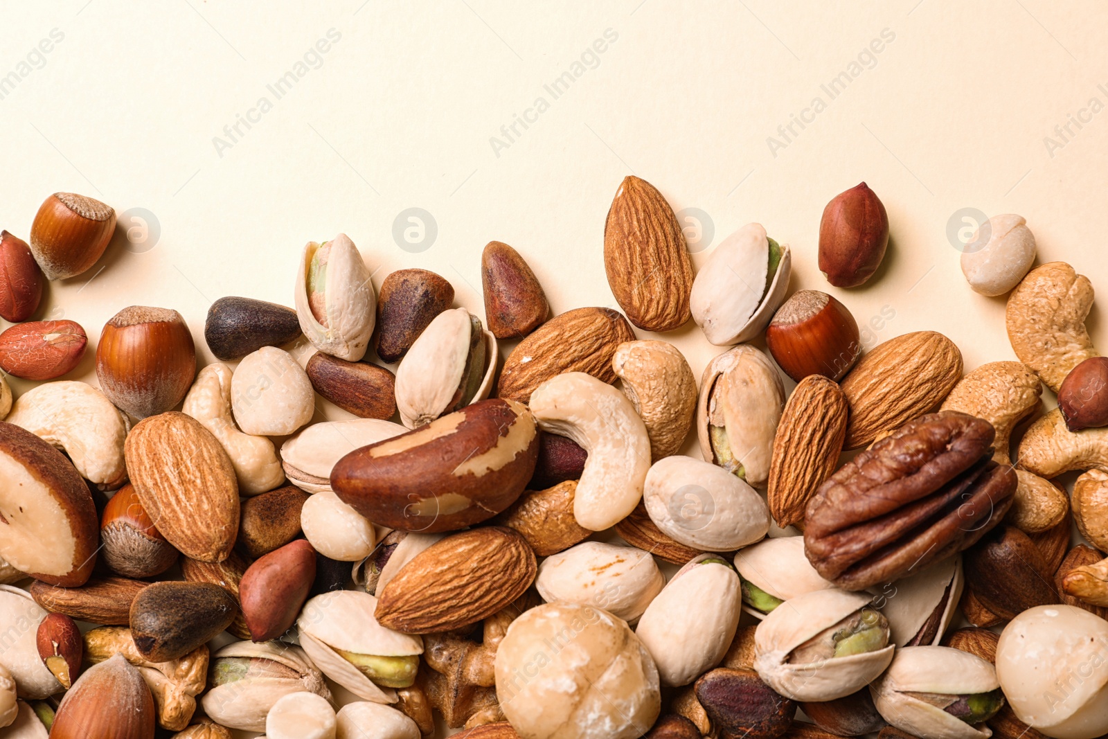 Photo of Flat lay composition with organic mixed nuts on color background