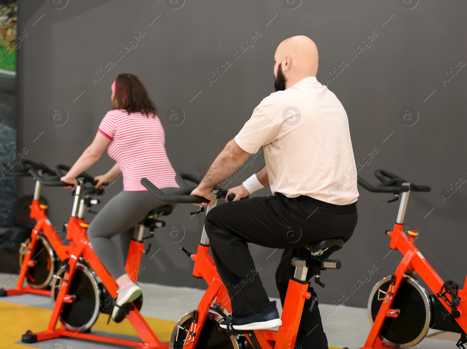 Photo of Overweight couple training in gym