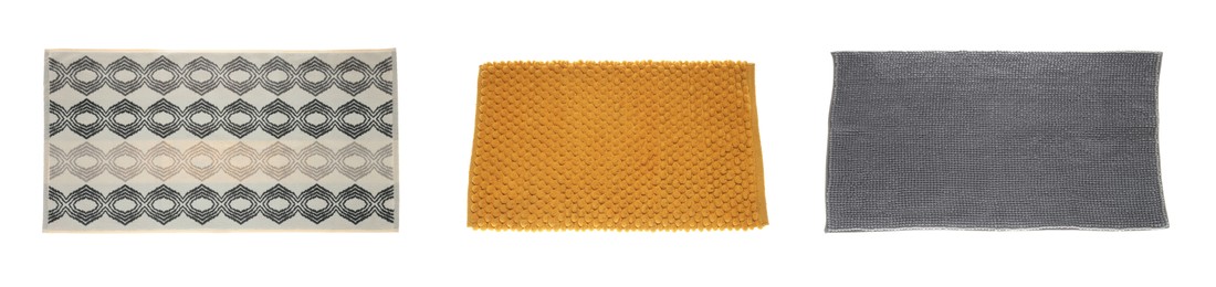 Set with soft bath mats on white background, top view. Banner design