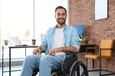 Photo of Portrait of young man in wheelchair at office