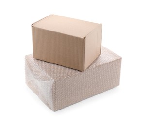 Photo of Cardboard box packed in bubble wrap and ordinary one on white background