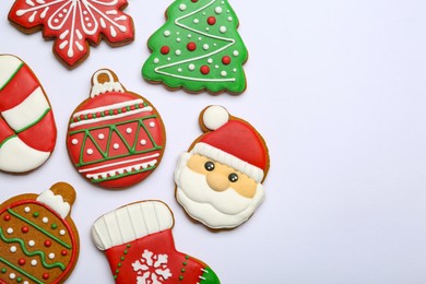 Different tasty Christmas cookies on white background, flat lay. Space for text