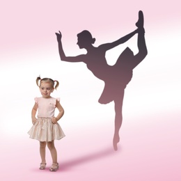 Image of Cute little girl dreaming to be ballet dancer. Silhouette of woman behind kid's back