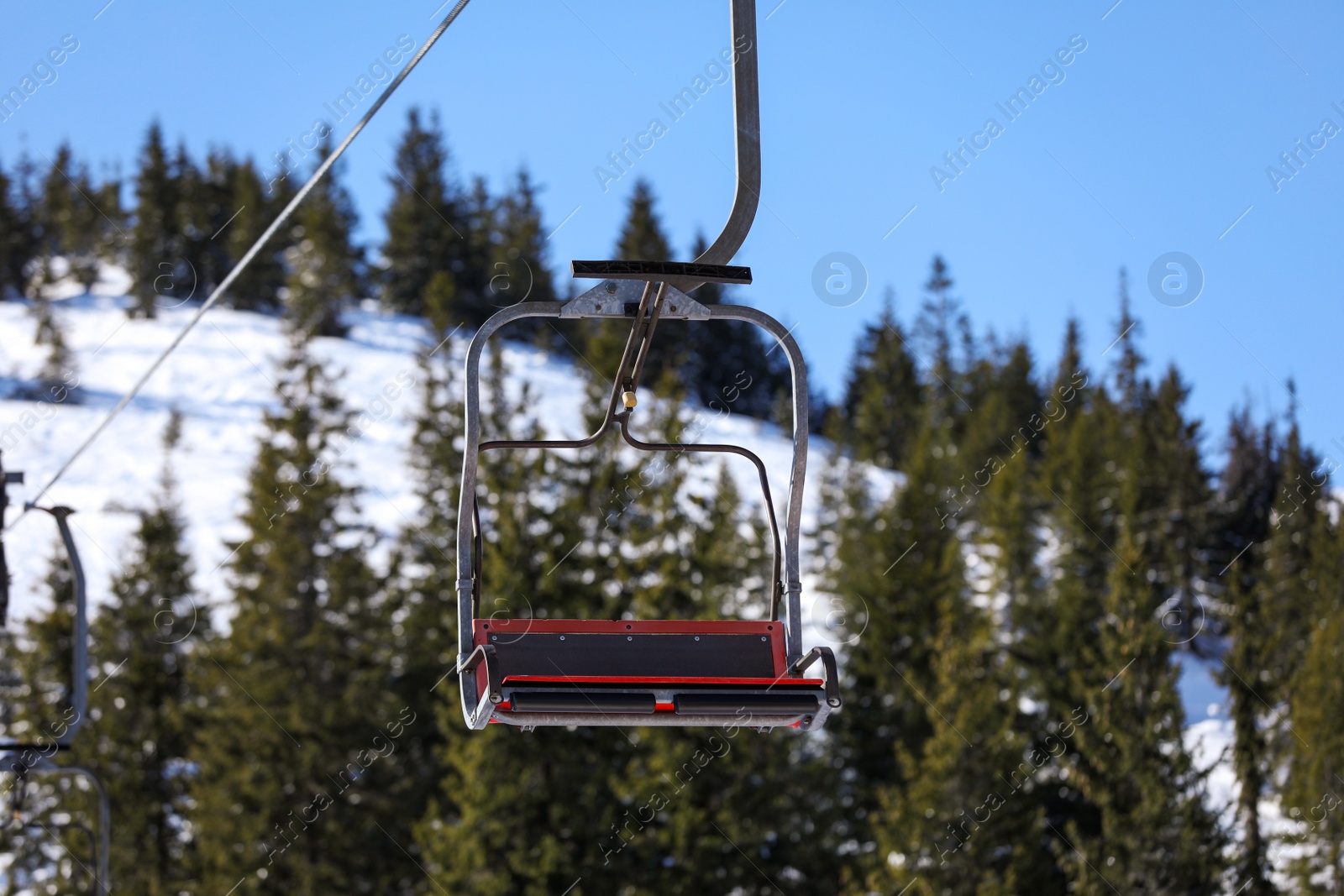 Photo of Empty chairlift at mountain ski resort. Winter vacation