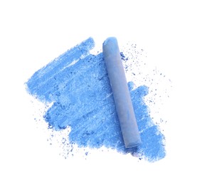 Photo of Blue pastel chalk on sheet of paper with scribble, top view. Drawing material