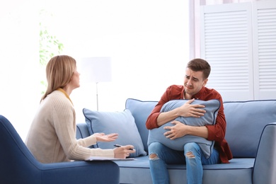 Female psychologist with client in office