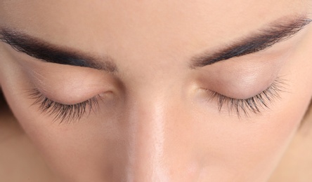 Young woman with beautiful natural eyelashes, closeup view