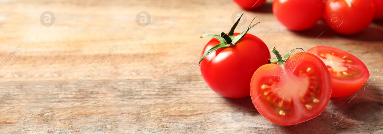 Image of Composition with fresh cherry tomatoes on wooden table, space for text. Banner design 