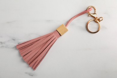 Photo of Leather keychain on white marble table, top view