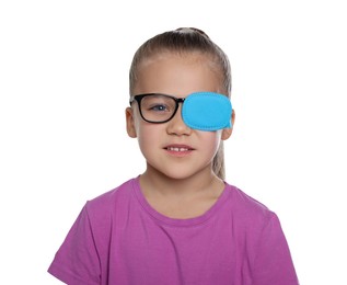Photo of Girl with eye patch on glasses against white background. Strabismus treatment