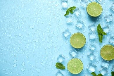 Photo of Ice cubes, mint and cut limes on turquoise background, flat lay with space for text. Refreshing drink ingredients