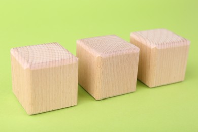 Photo of International Organization for Standardization. Wooden cubes with abbreviation ISO on light green background, closeup