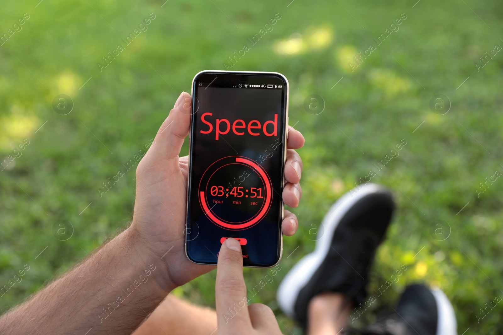 Photo of Man using fitness app on smartphone outdoors, closeup