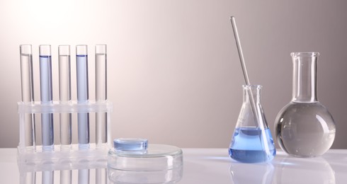 Photo of Laboratory analysis. Different glassware on table against light background