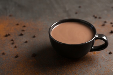 Cup of tasty hot chocolate on table. Space for text