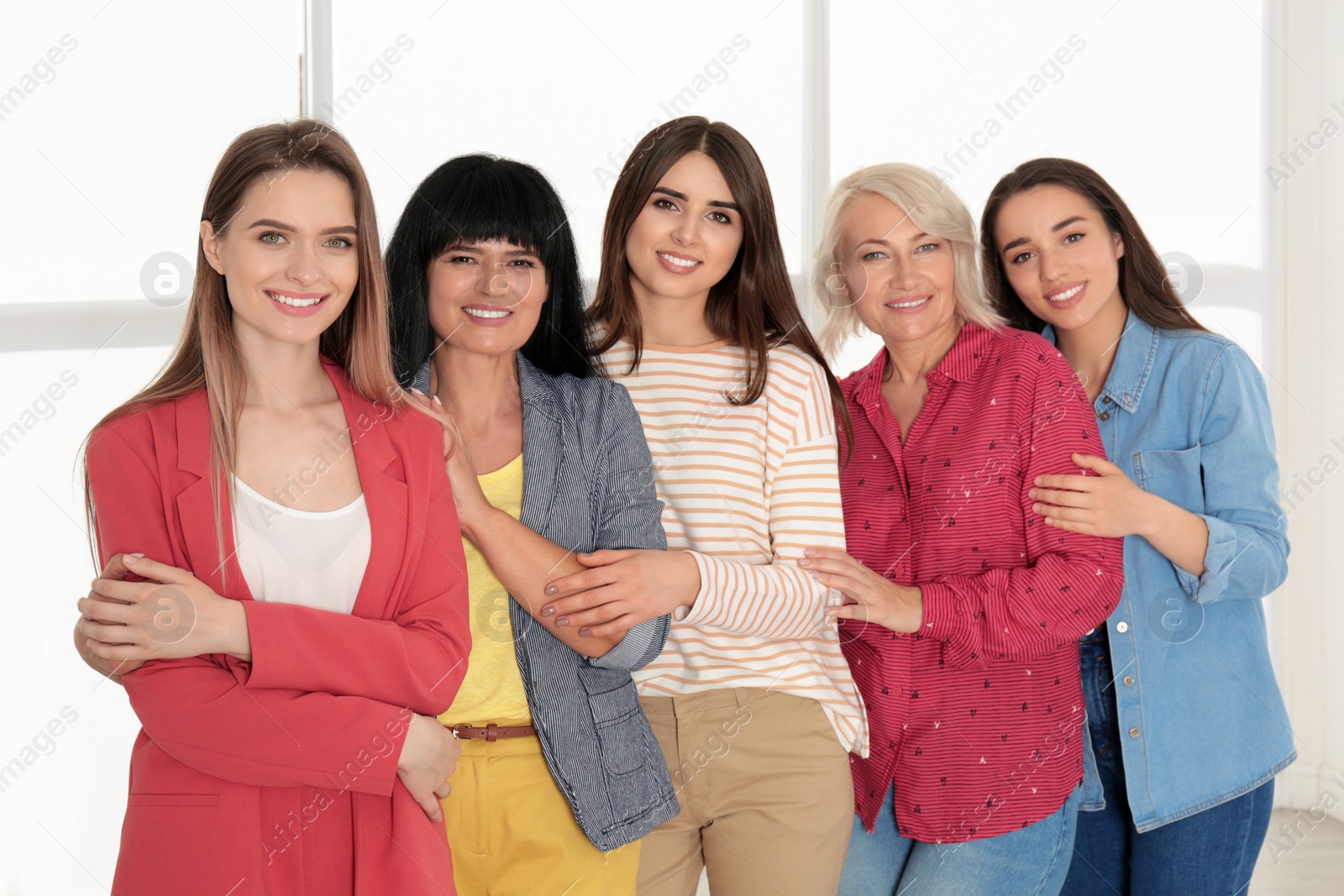 Photo of Group of ladies near window indoors. Women power concept