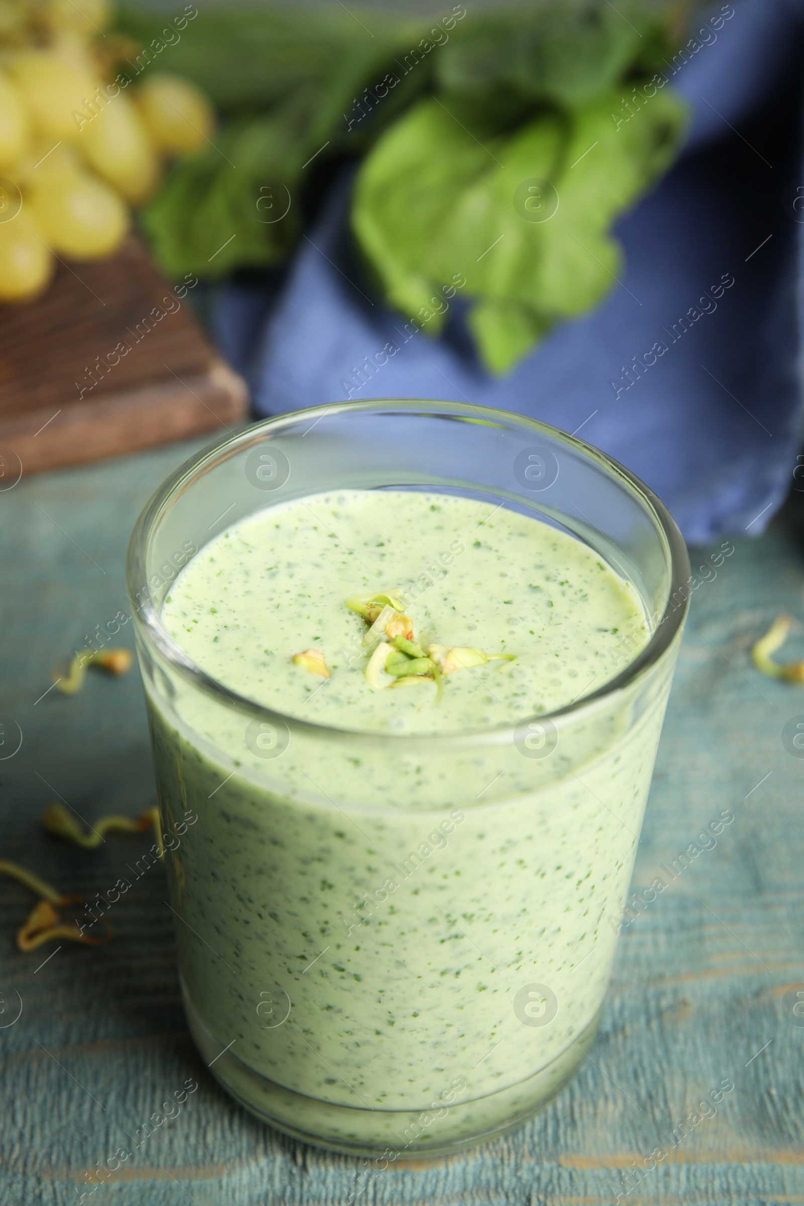 Photo of Green buckwheat smoothie on light blue wooden table