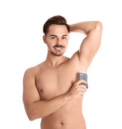 Young man using deodorant on white background