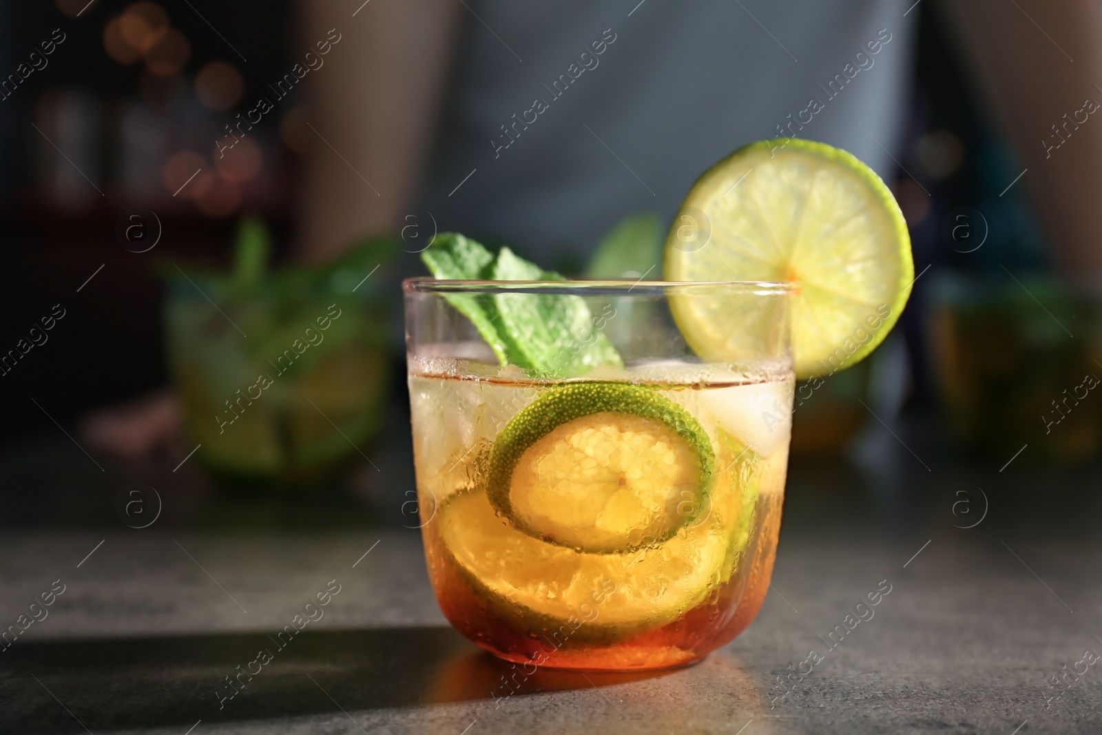 Photo of Glass with delicious mint julep cocktail on bar counter